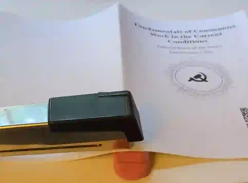 Stapler stapling into the stack of papers with an eraser below it